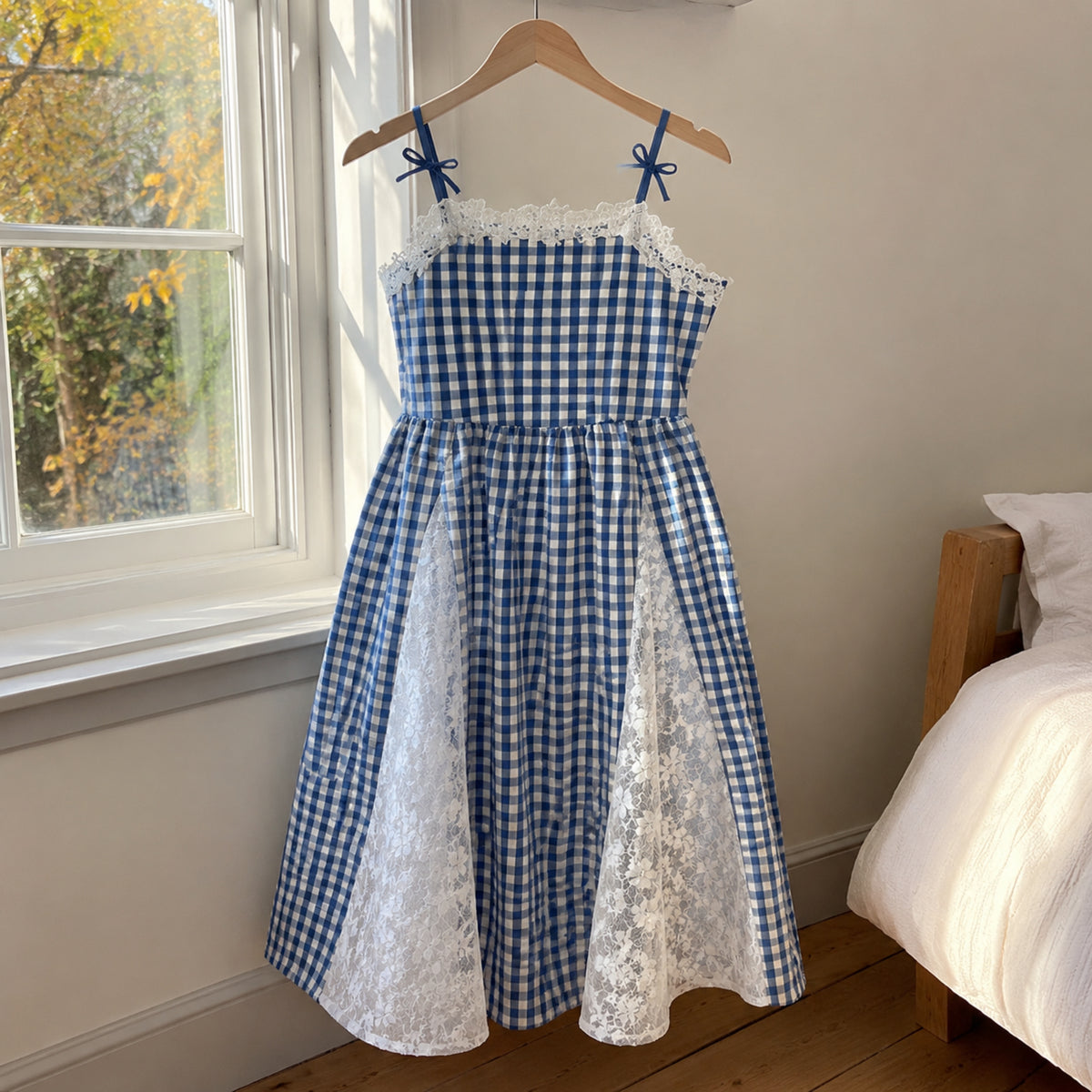 Girls royal blue and white gingham ankle-length dress with floral lace panels on a hanger