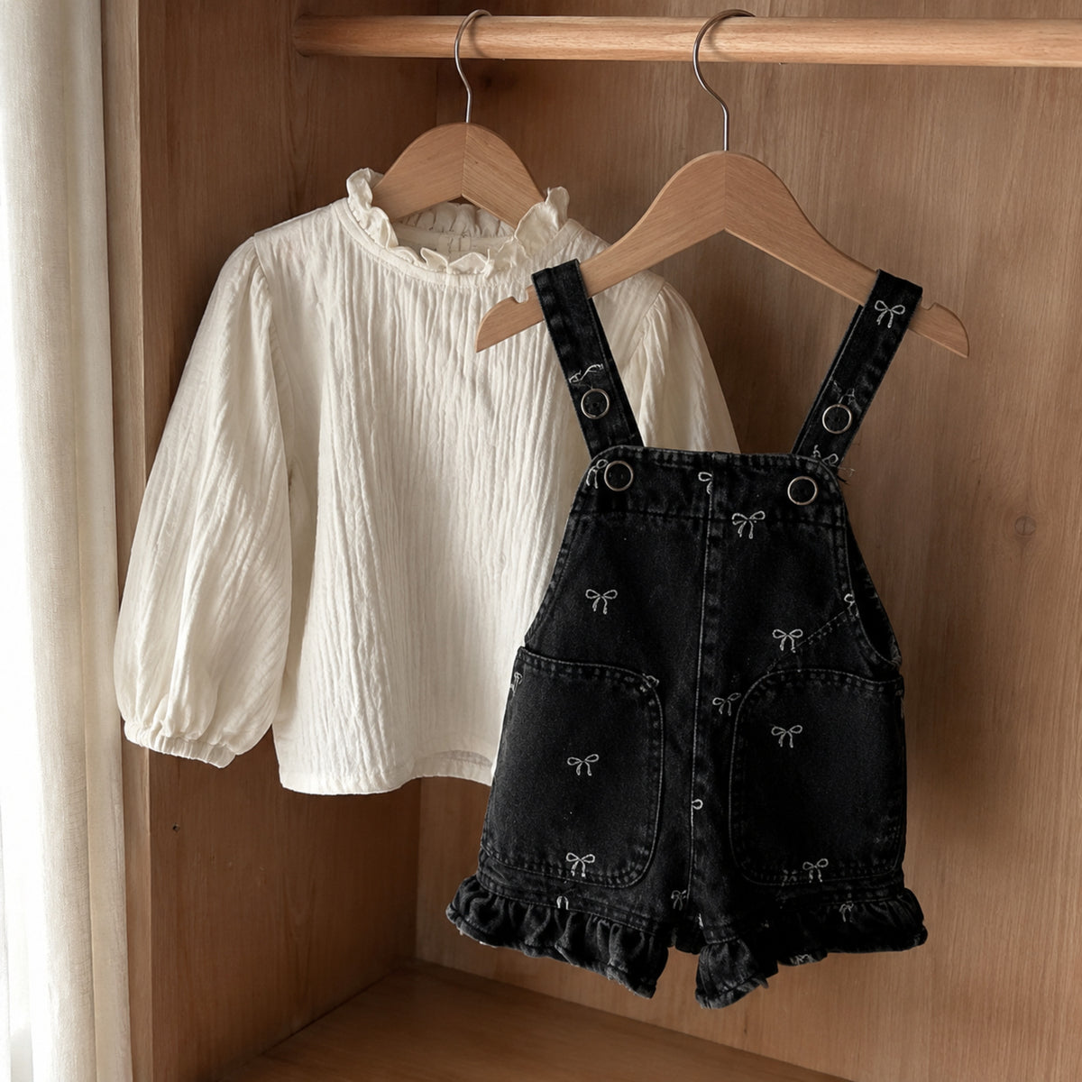 Ivory ruffle blouse and black bow denim suspender shorts romper shown as separate styles