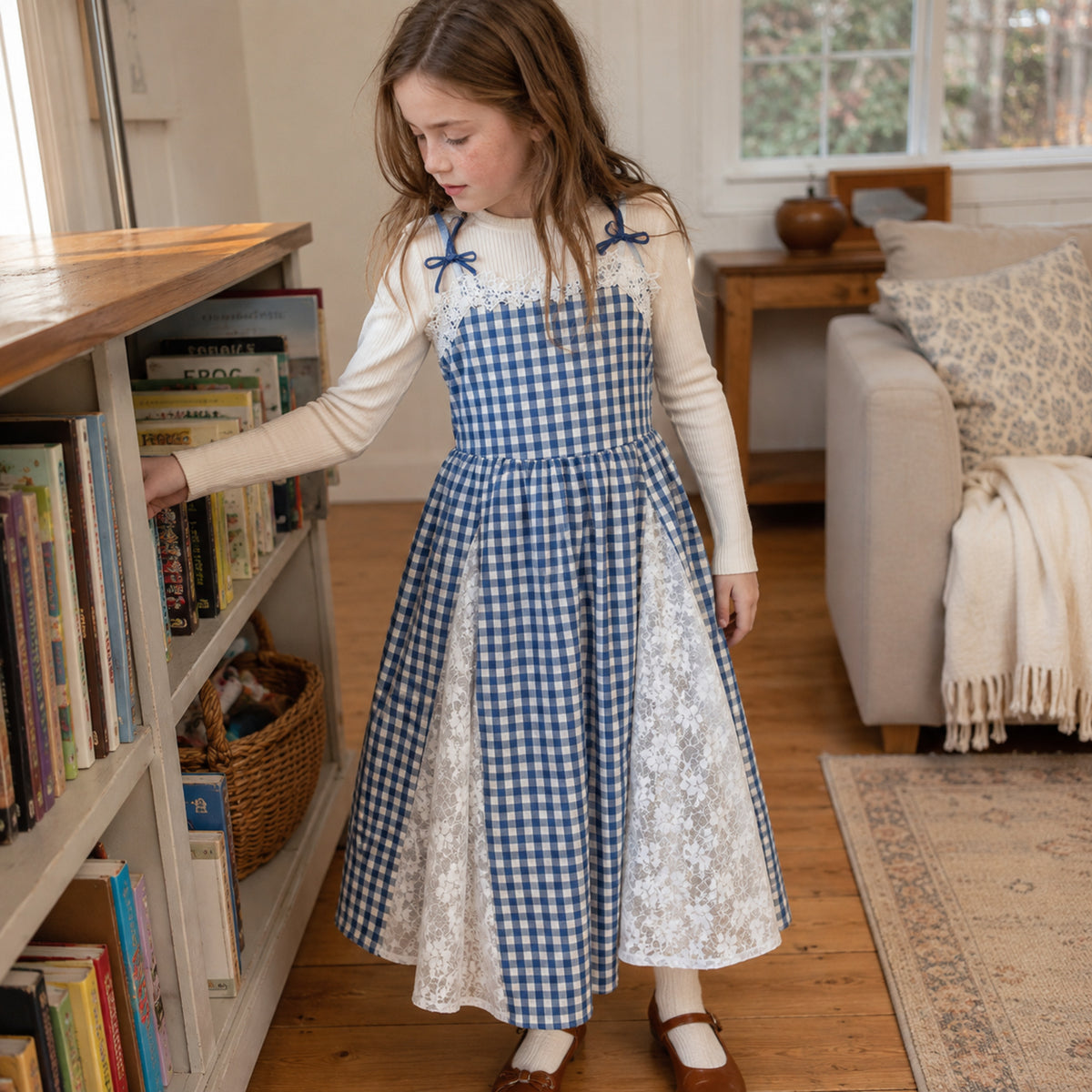 Seven-year-old wearing blue gingham lace dress with ivory top and cream tights at home