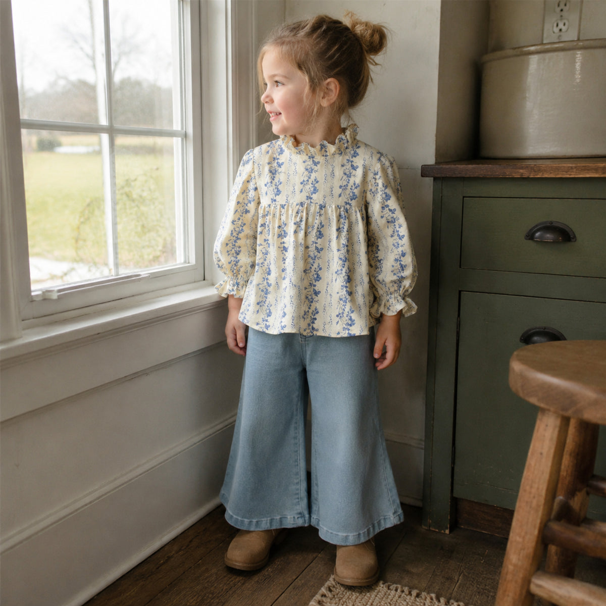 Young girl wearing the blue botanical blouse with light denim bell-bottom pants for fall