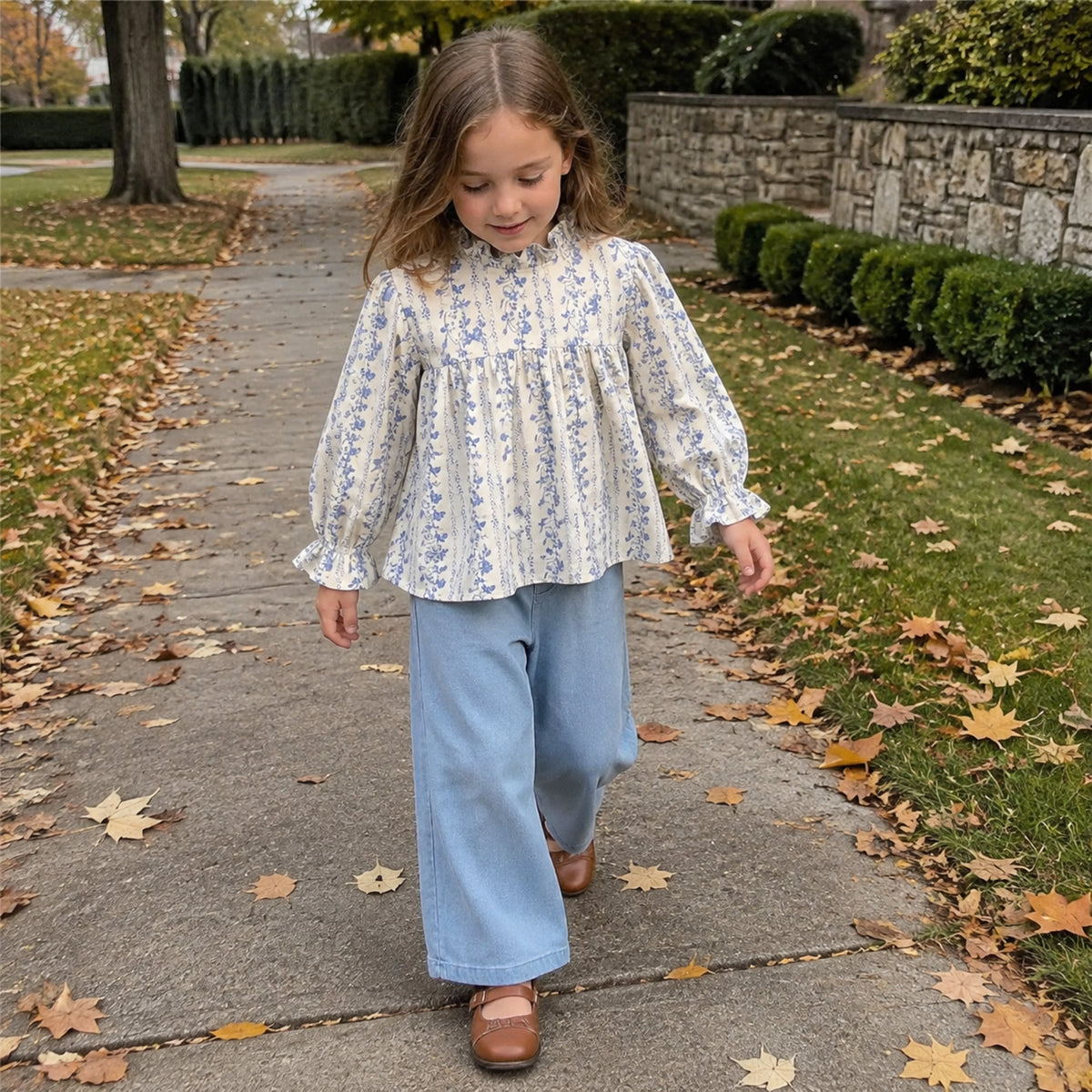 Older girl walking in the blue floral blouse and light denim wide-leg pants