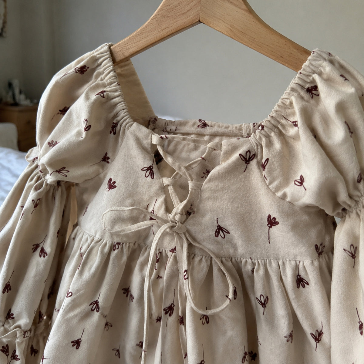 Close-up of the square neckline and delicate tie details