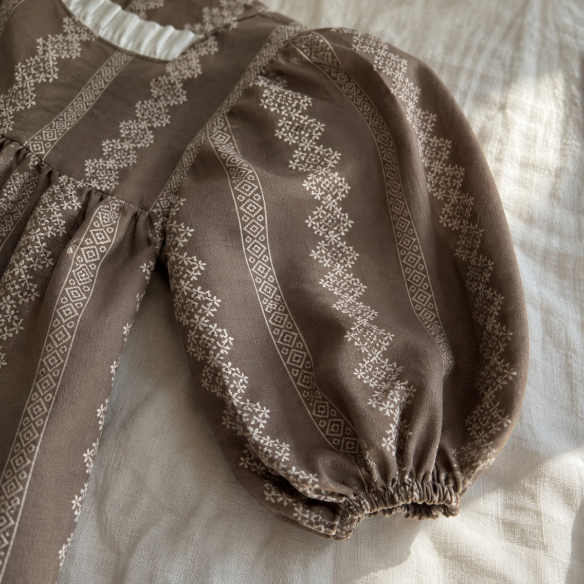 Close-up of the long balloon sleeve and softly gathered elastic cuff