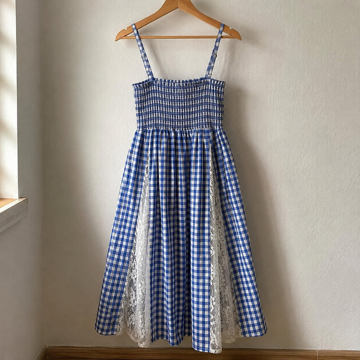 Back view of blue gingham maxi dress showing elastic smocked bodice and long skirt