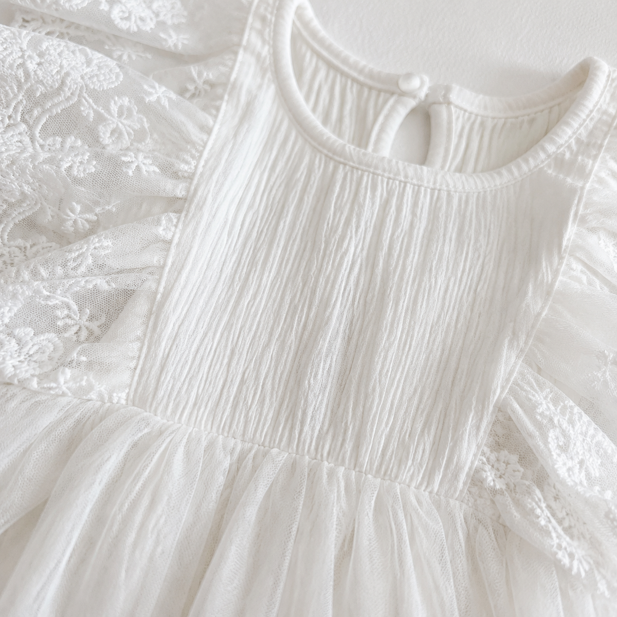 Close-up of textured cotton bodice and gathered waist