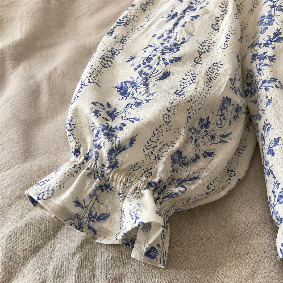 Close-up of the blue botanical blouse balloon sleeve and flutter cuff