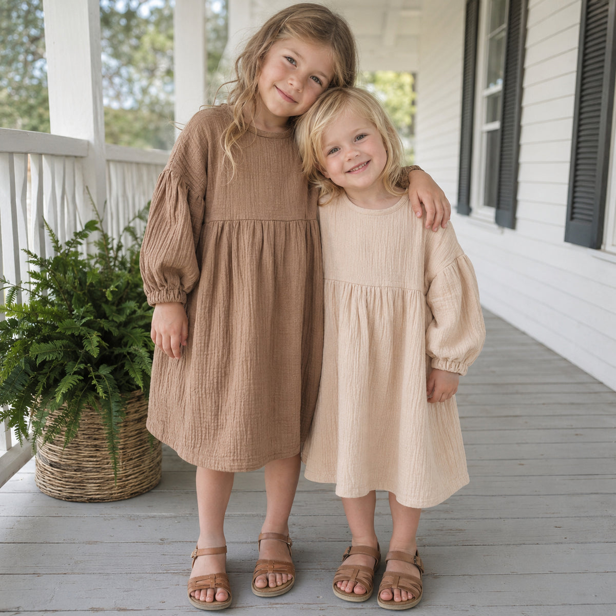 Sisters wearing beige and brown muslin dresses