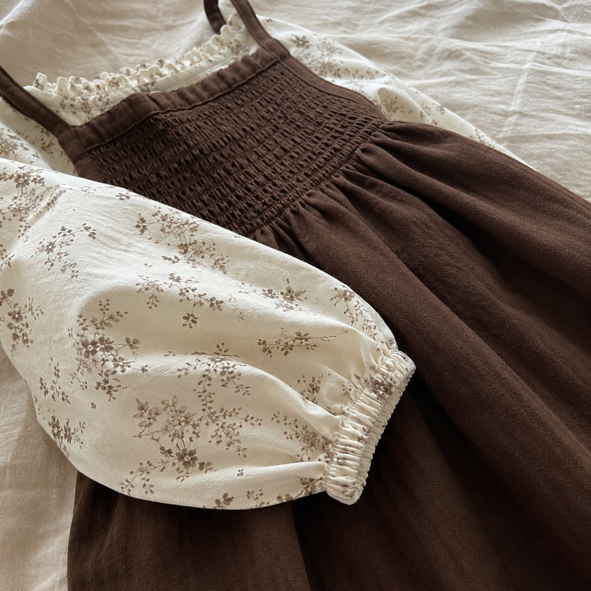 Close-up of the ivory floral balloon sleeve and elastic cuff