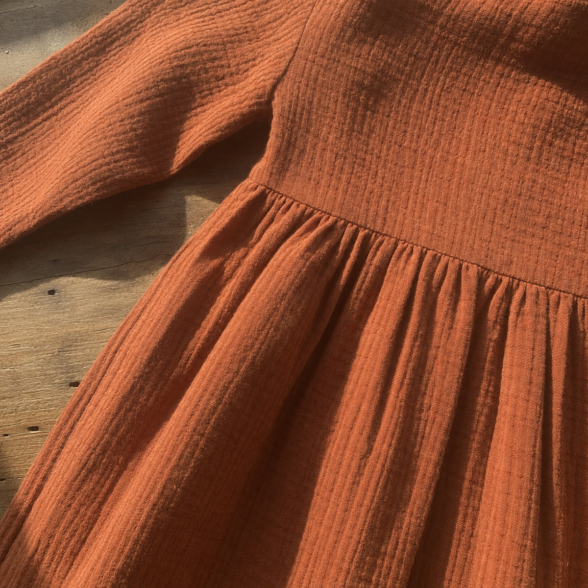 Rust gauze dress gathered waist seam close up
