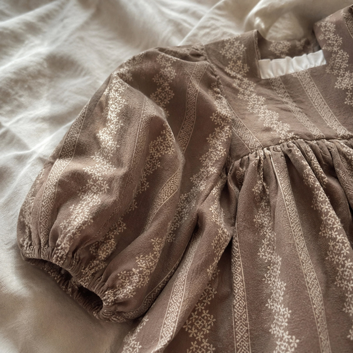Close-up of the gathered high waist seam and cotton floral fabric