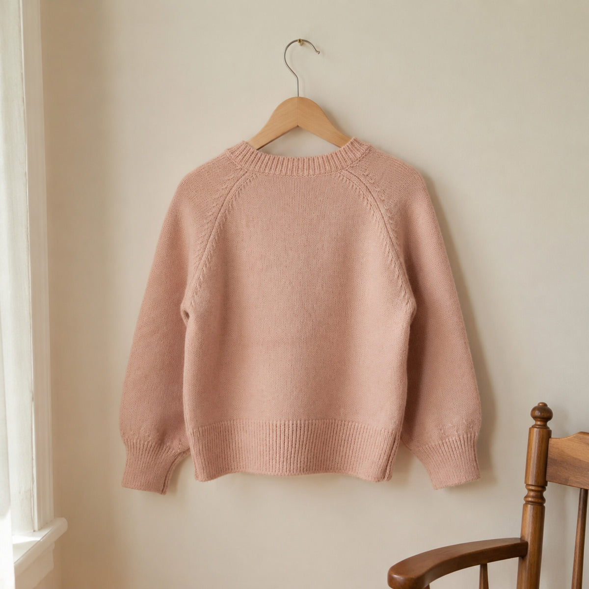 Back view of the dusty pink raglan knit sweater