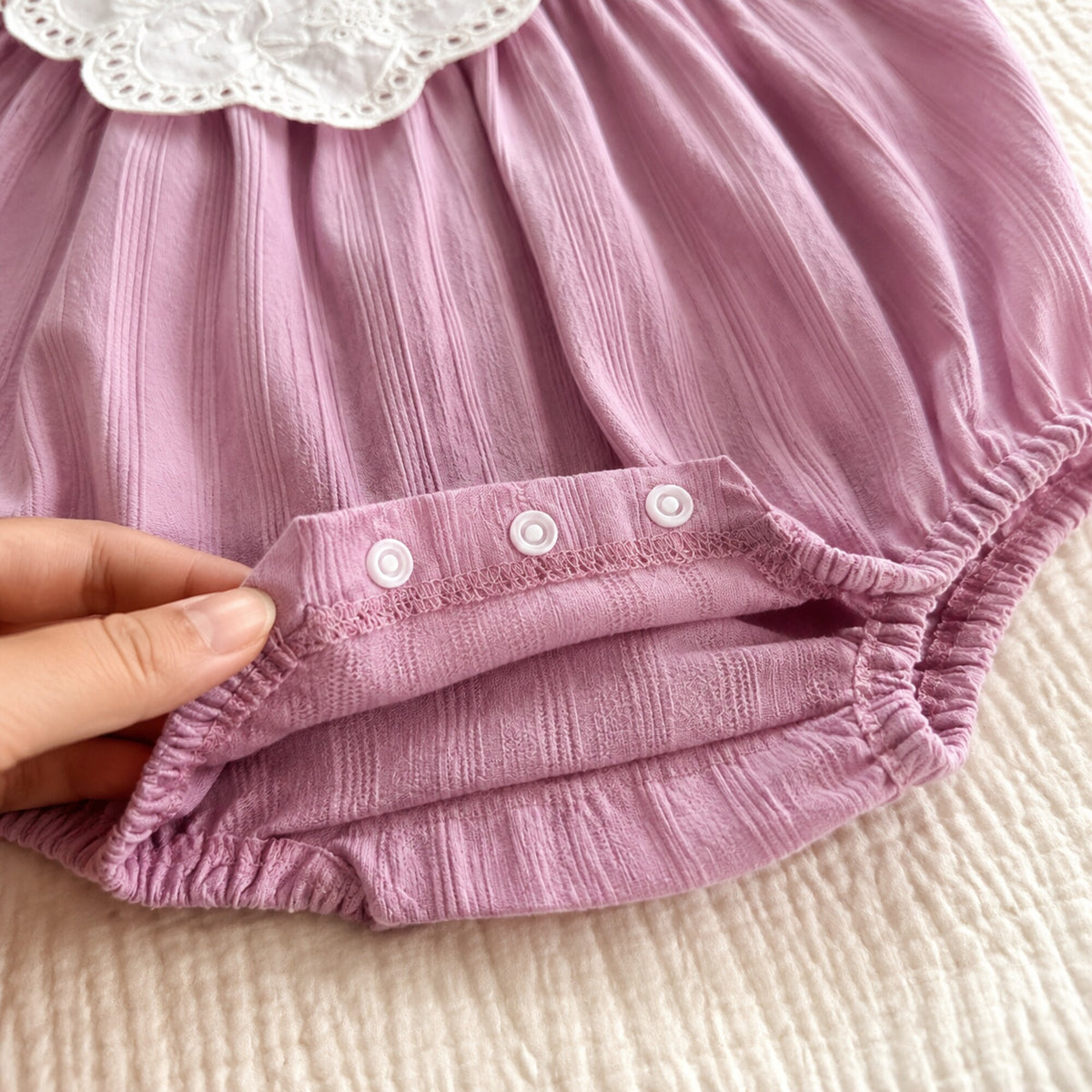 Close-up of the romper crotch snaps and elastic leg openings