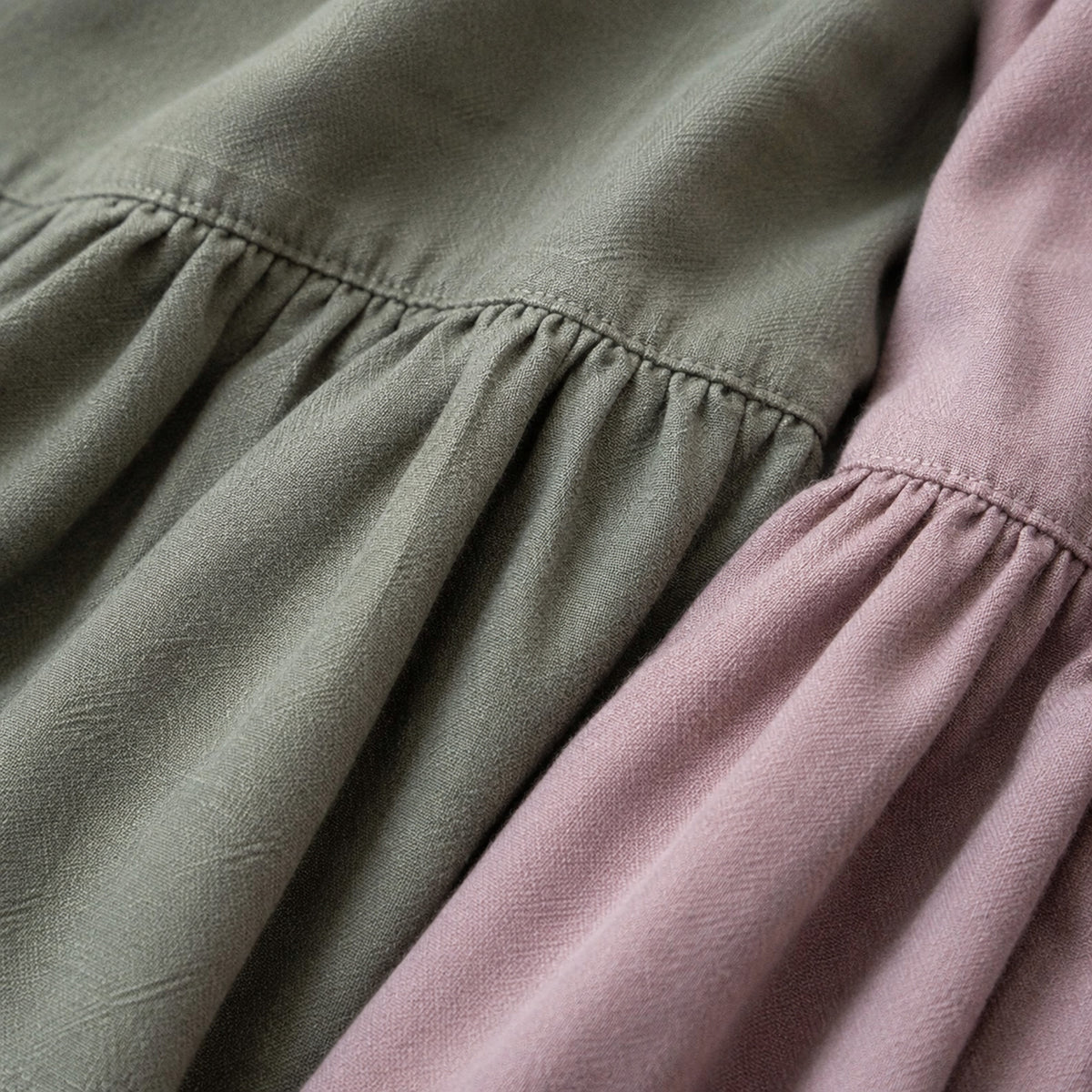 Close-up of the gathered linen texture in gray green and dusty mauve