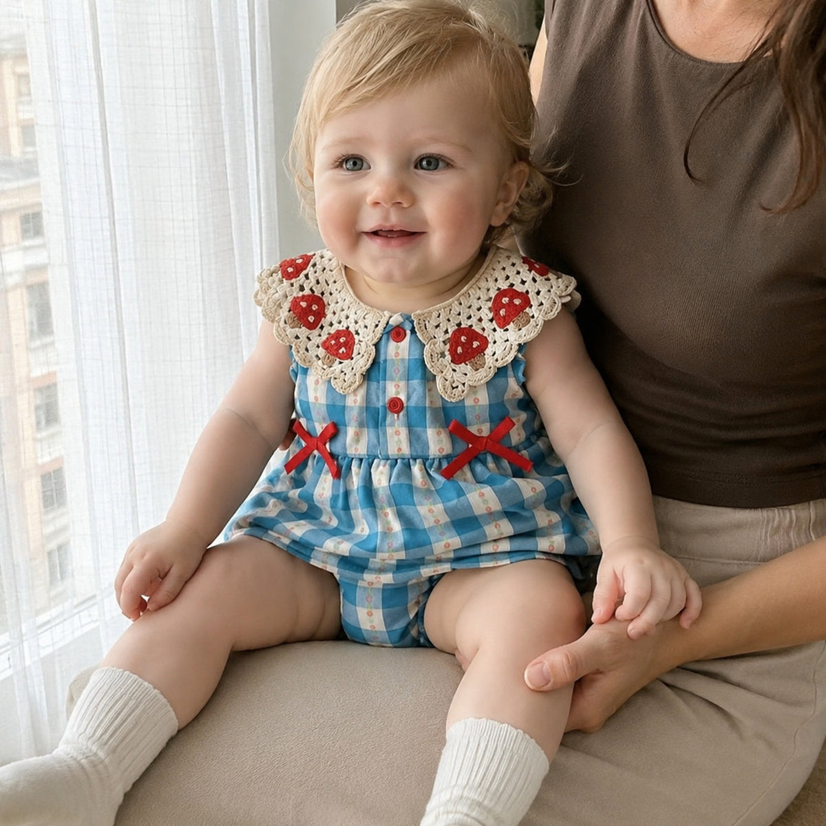 Baby blue gingham romper dress with crochet strawberry collar and red bows - cozy seasonal lifestyle view