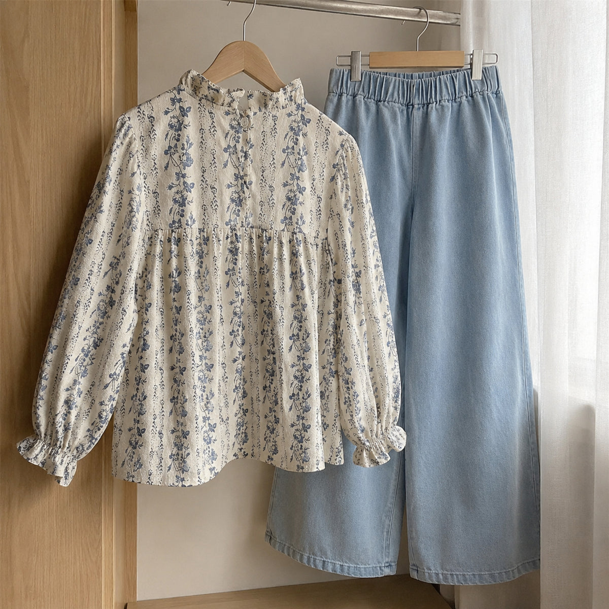 Blue floral blouse and light denim pants hanging naturally in a wardrobe