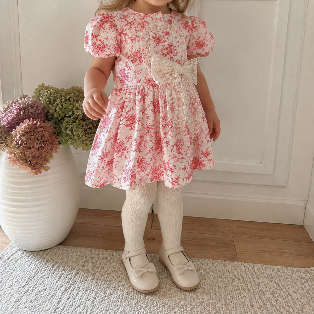 Girl wearing raspberry toile dress with cream tights