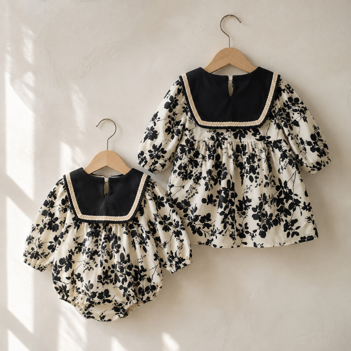 Back views of the black floral bubble romper and sailor collar dress
