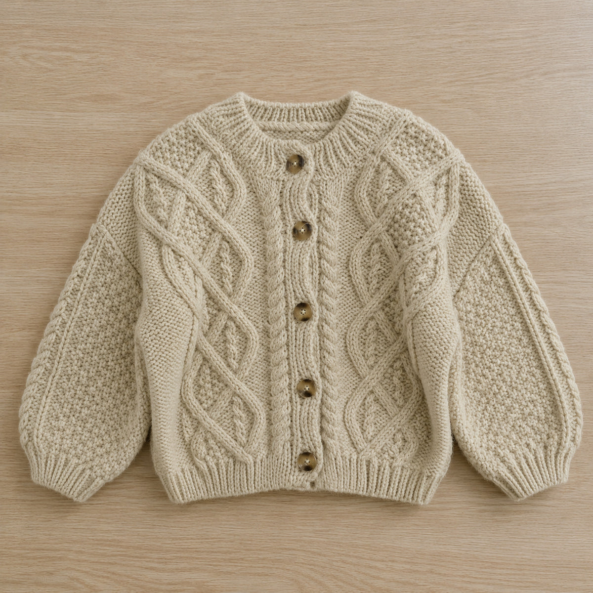 Cream cable-knit cardigan front view