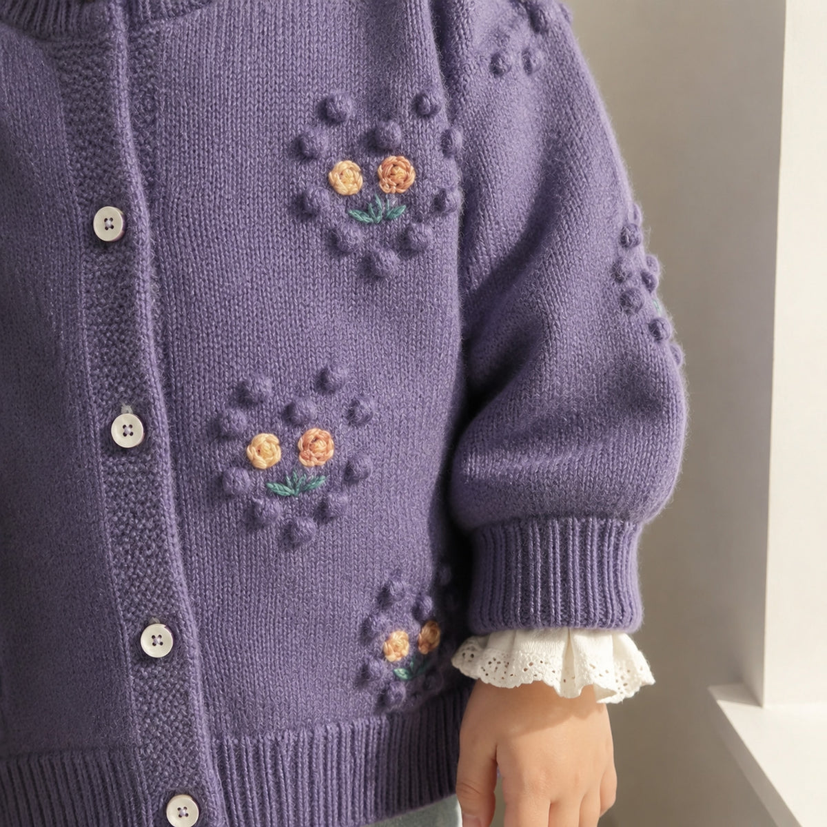 Sleeve cuff and floral bobble detail on girls purple cardigan
