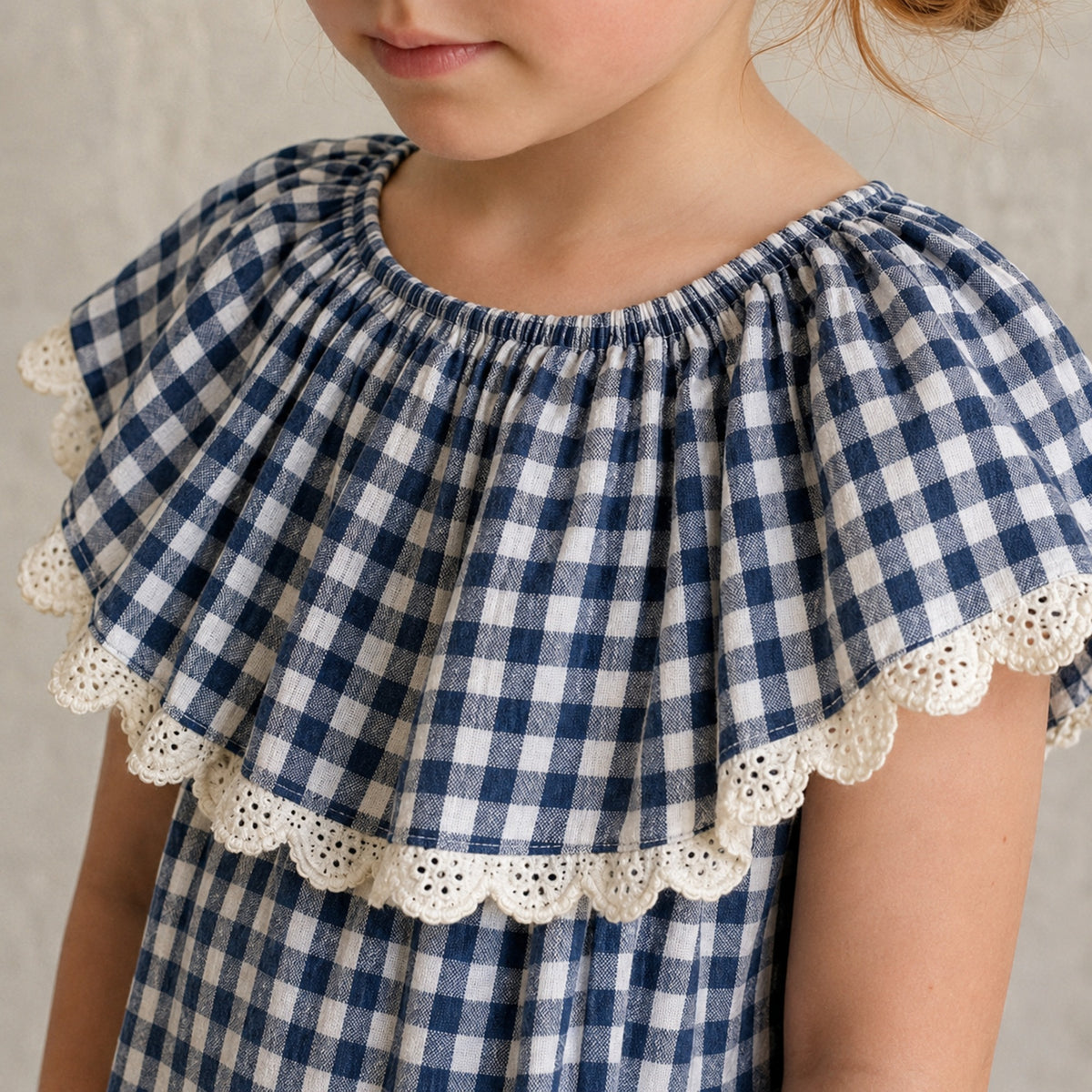 Wide gingham ruffle and eyelet trim close detail