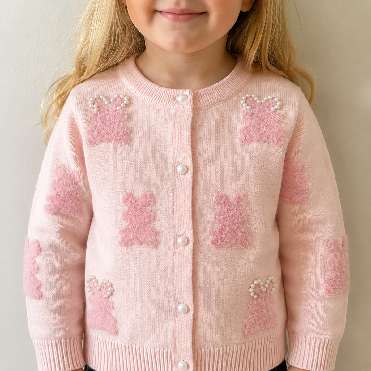 Front close-up of girls pink bunny cardigan with pearl-look buttons