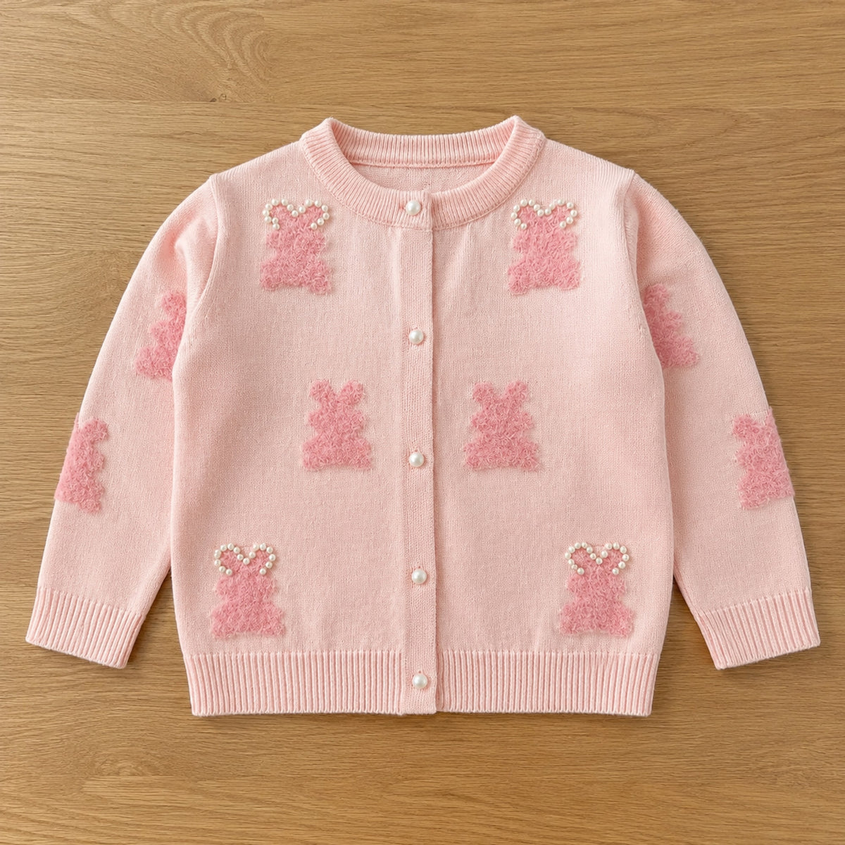 Girls light pink bunny motif knit cardigan flat lay