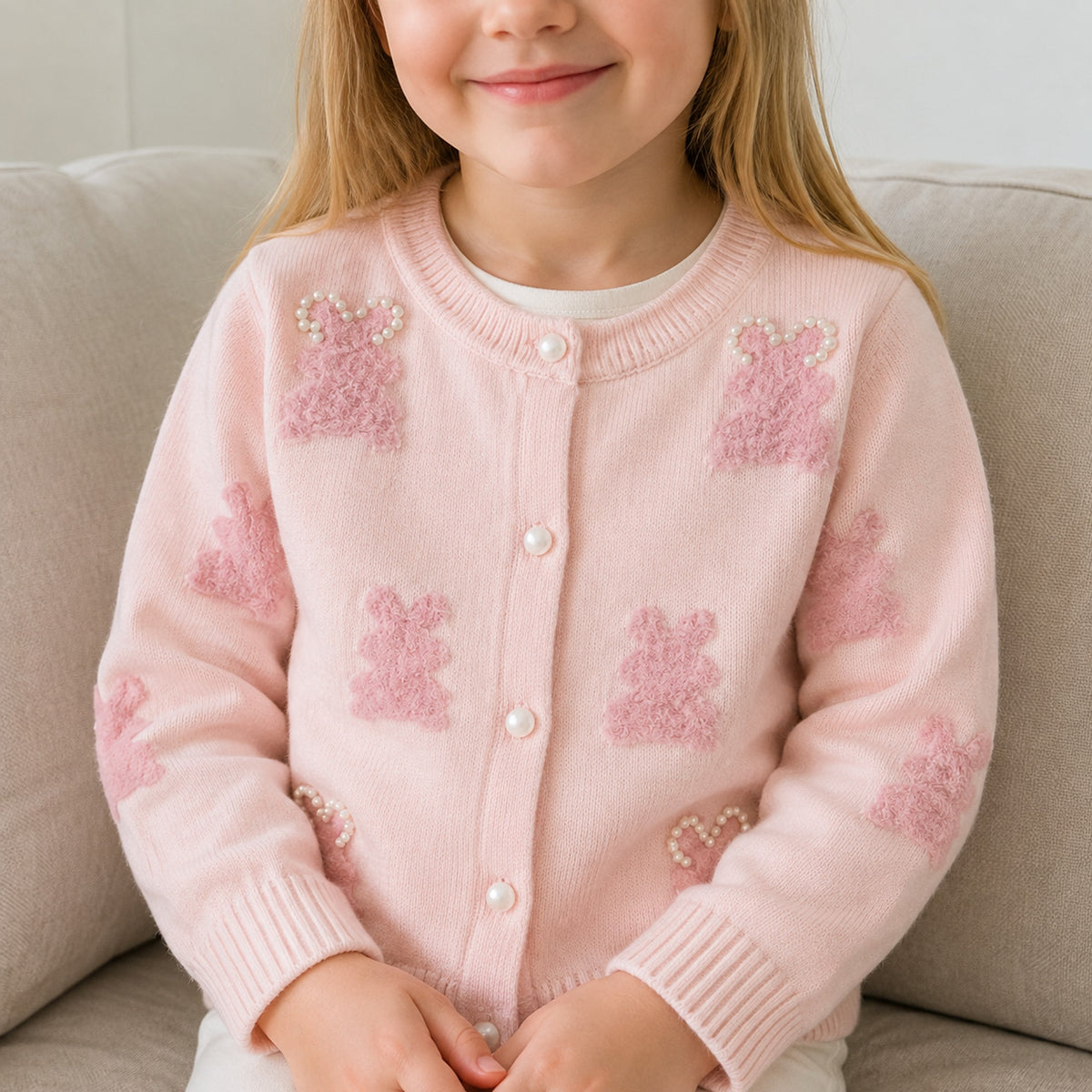 Girls pink bunny pearl detail cardigan in a natural home setting