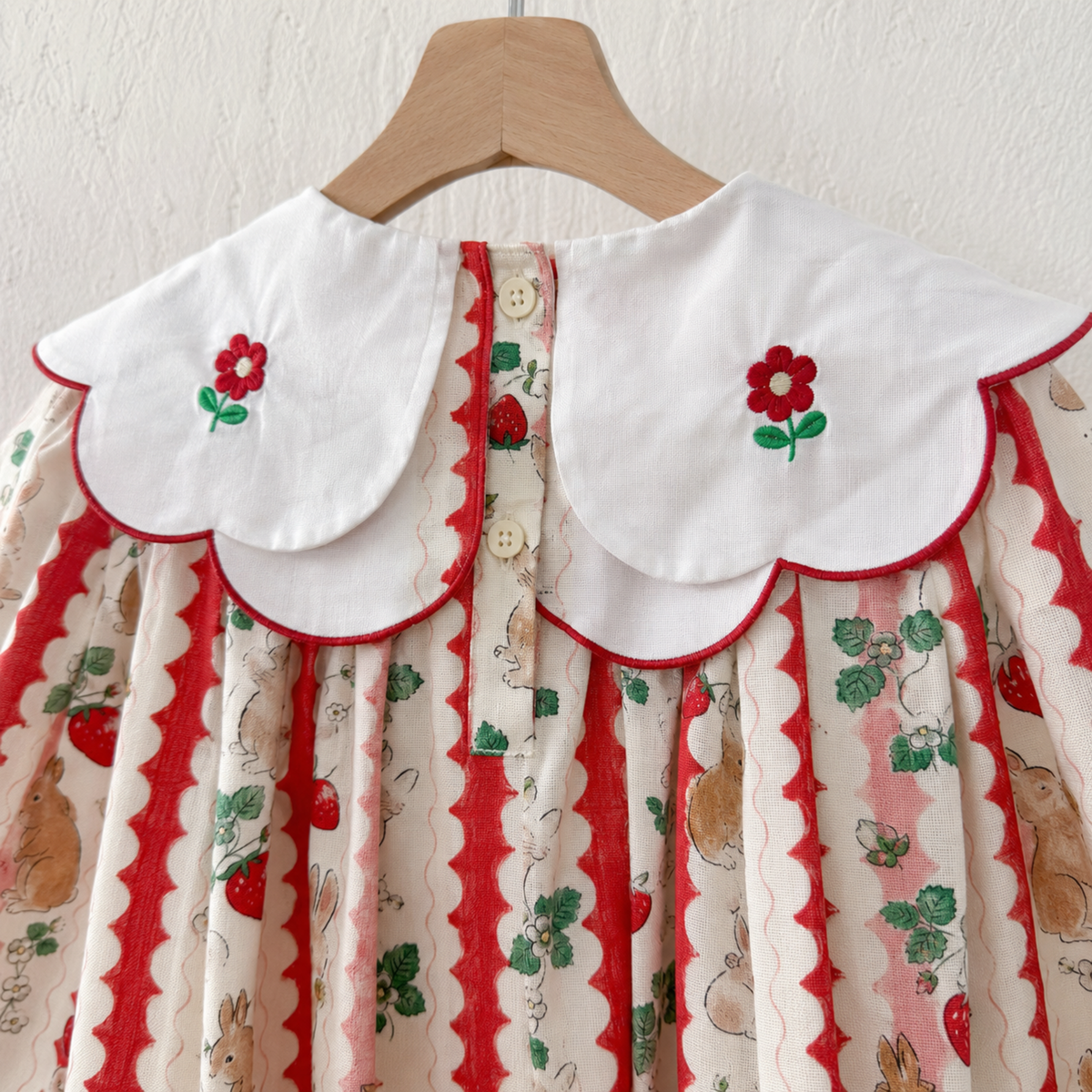 Back buttons and layered scalloped collar detail