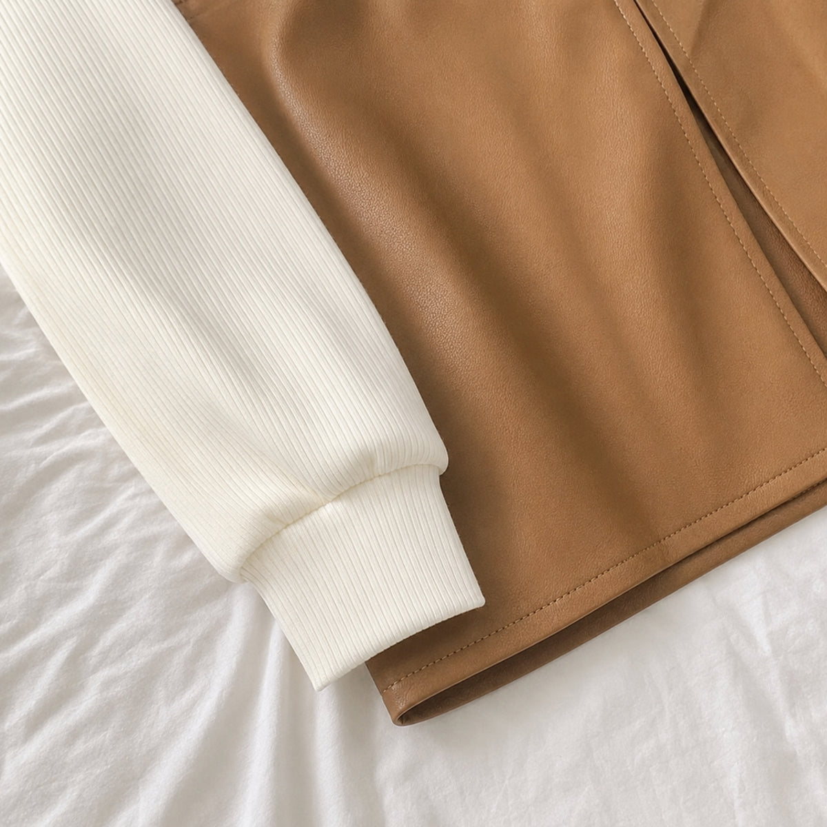 Camel tan faux leather skirt stitching and cream ribbed sleeve detail