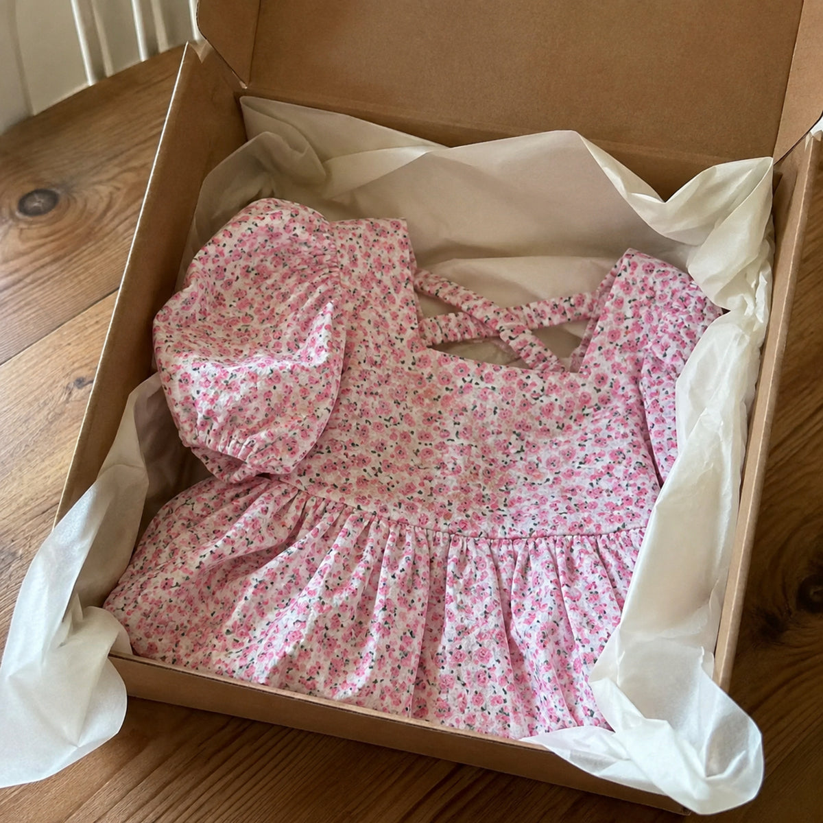 Floral puff sleeve girls dress prepared as a thoughtful gift