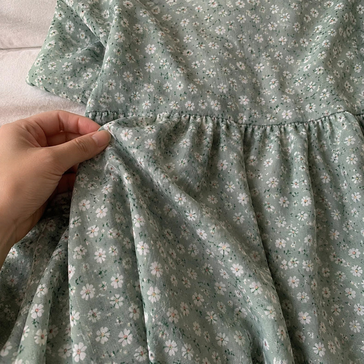 Close-up of the sage green floral dress gathered waist and fabric