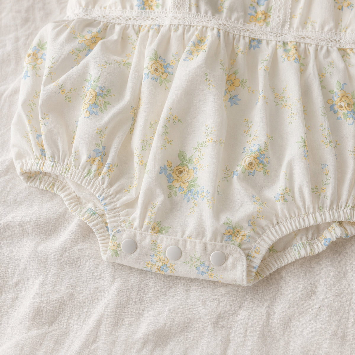 Baby romper elastic leg and snap fastening detail