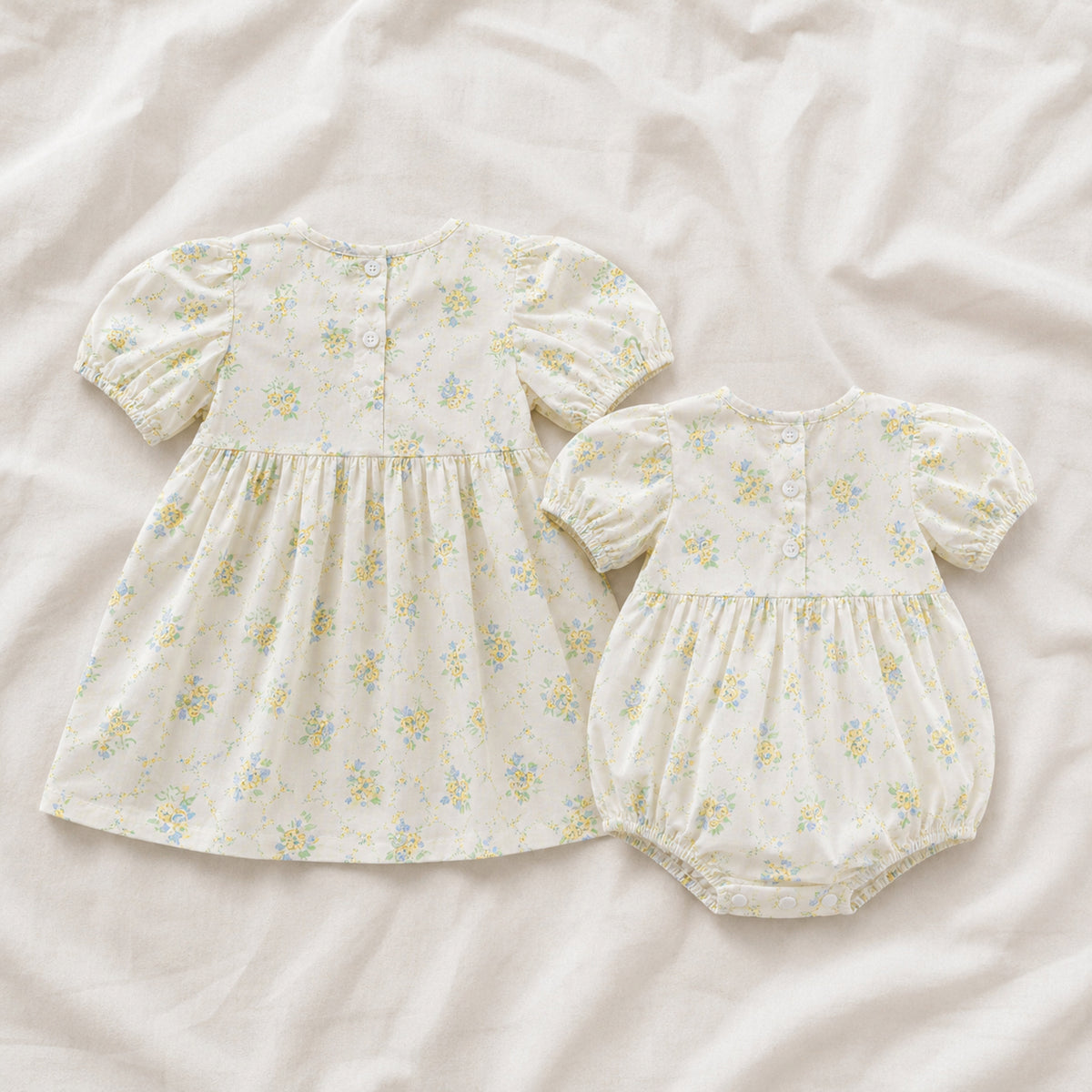 Back view of floral baby romper and toddler dress