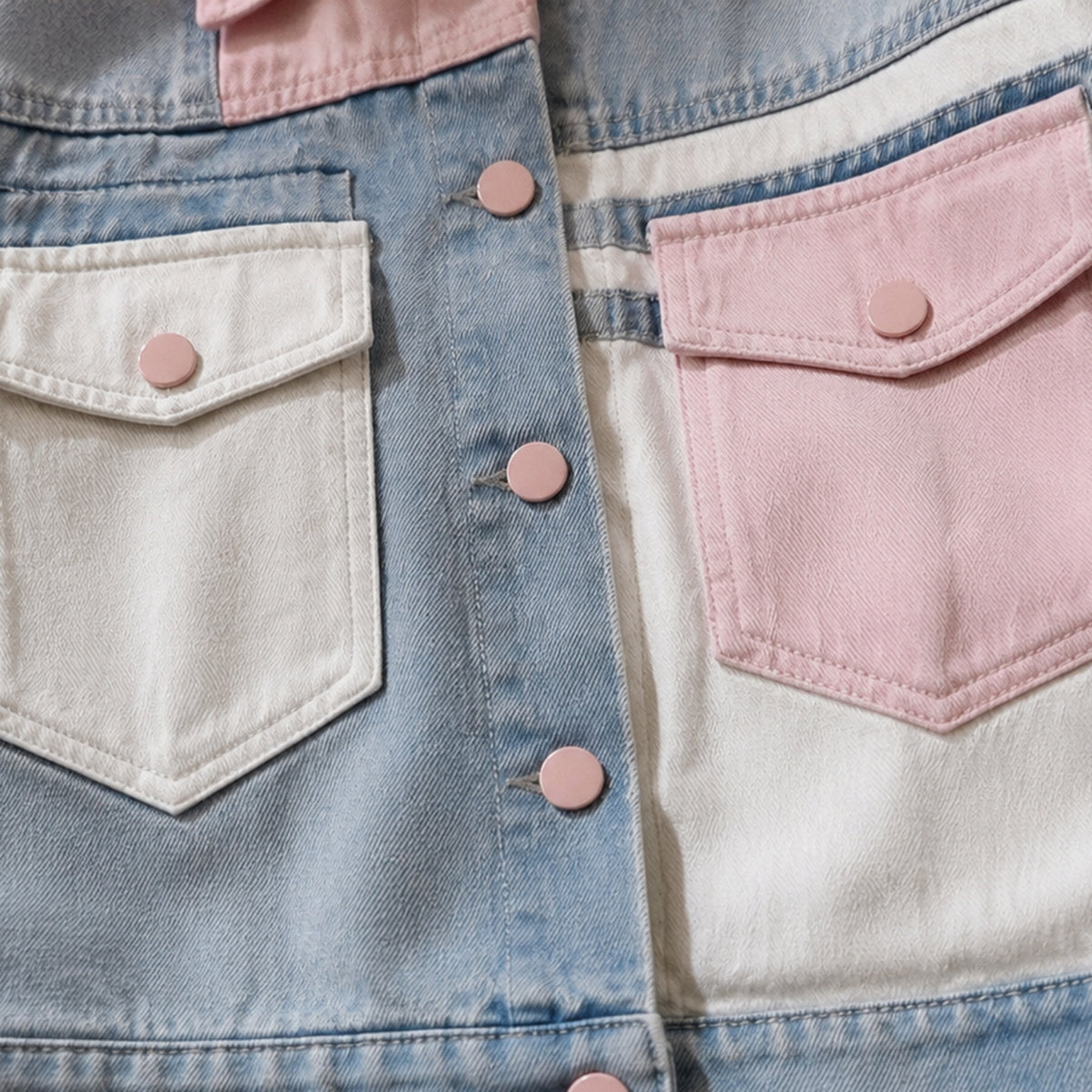 Close-up of the cream and pink mismatched flap pockets on the denim jacket