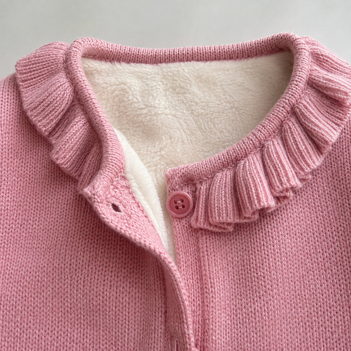 Pink ruffle collar and fleece lining detail