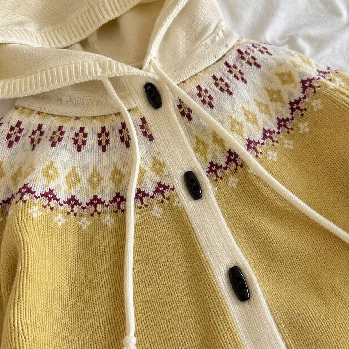 Yellow cardigan cream jacquard yoke, drawstrings and dark button detail