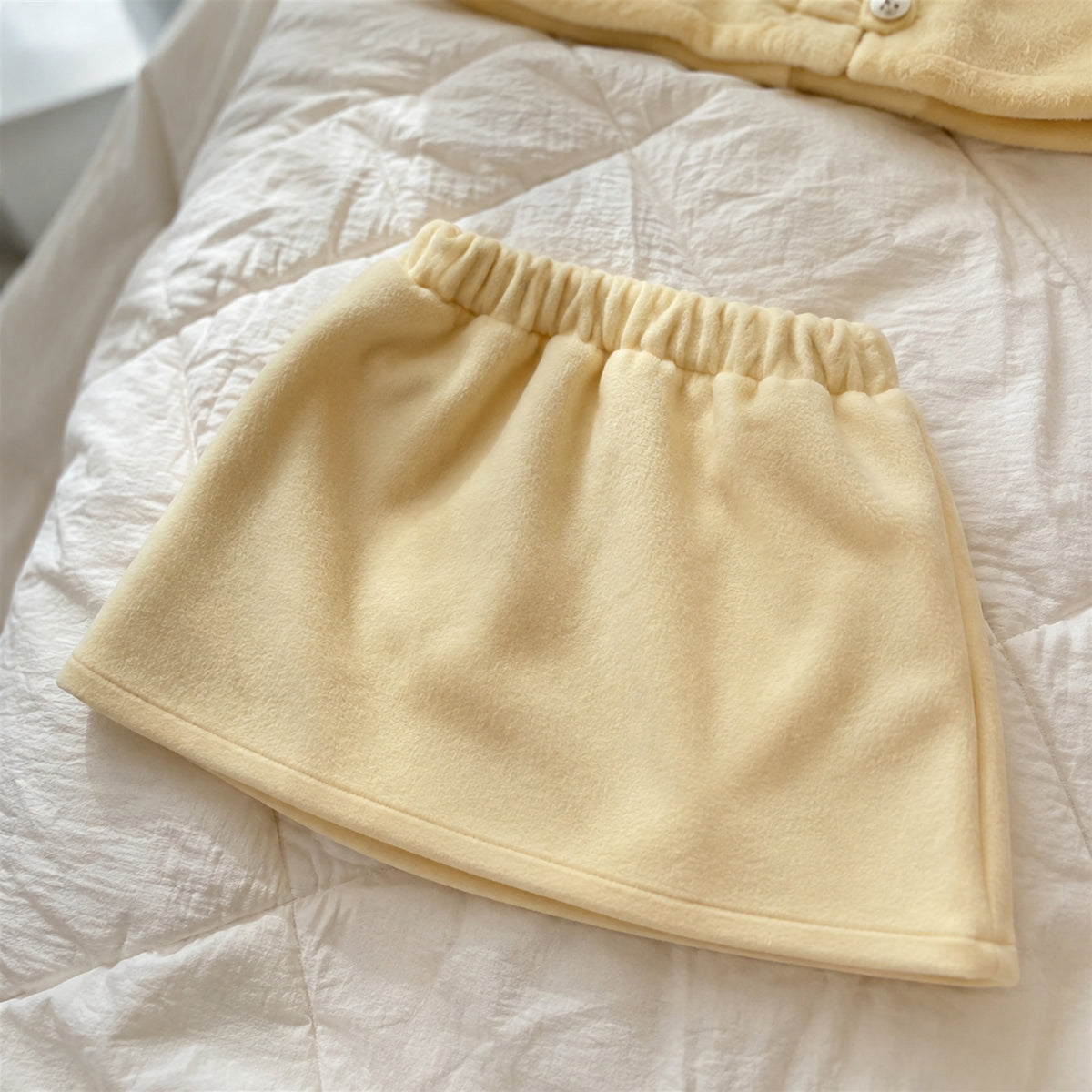 Close-up of the matching yellow skirt elastic waist and A-line shape