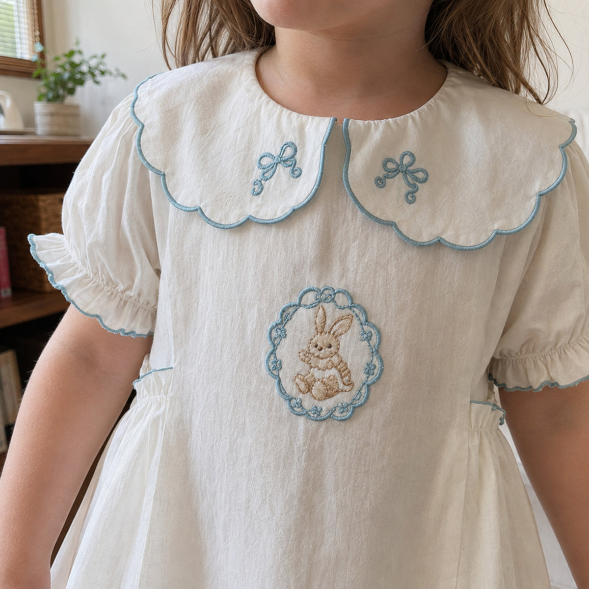 Girls Blue Bunny Cotton Dress, Scalloped Peter Pan Collar — independent bunny medallion detail