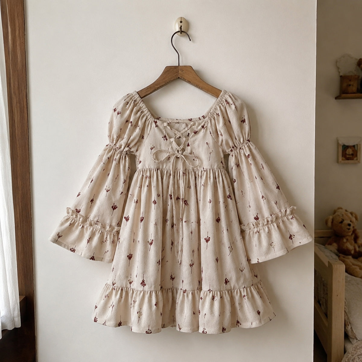 Beige floral puff-sleeve ruffle dress hanging in a bright neutral home