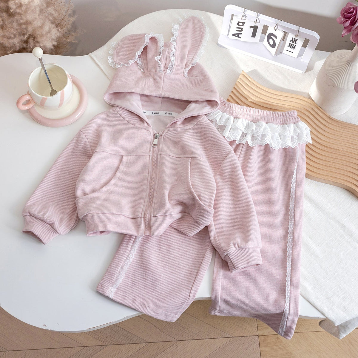 Dusty pink bunny-ear hoodie and matching lace ruffle pants product view
