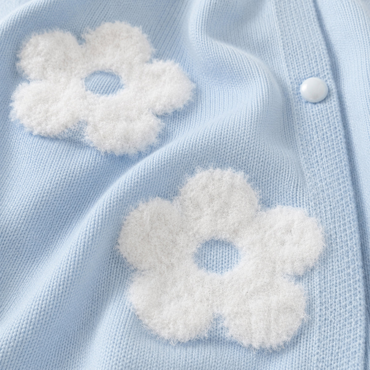 Light blue cardigan fluffy white flowers and button detail