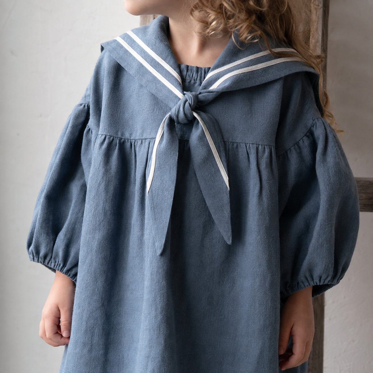 Girls Linen Sailor Dress in Black, Ivory or Blue — styled flat lay