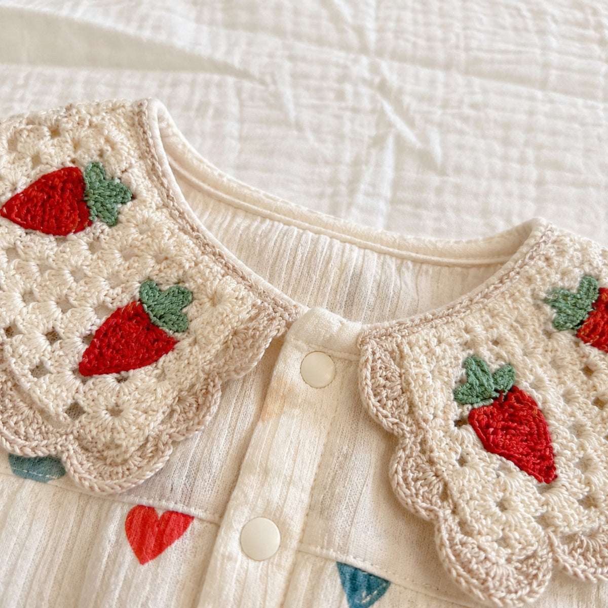 Close-up of double crochet collar with red strawberry motifs
