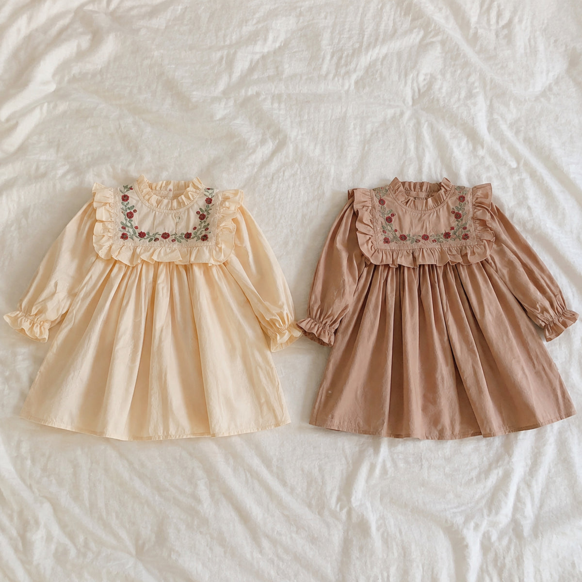Embroidered ruffle bib dresses in apricot and khaki