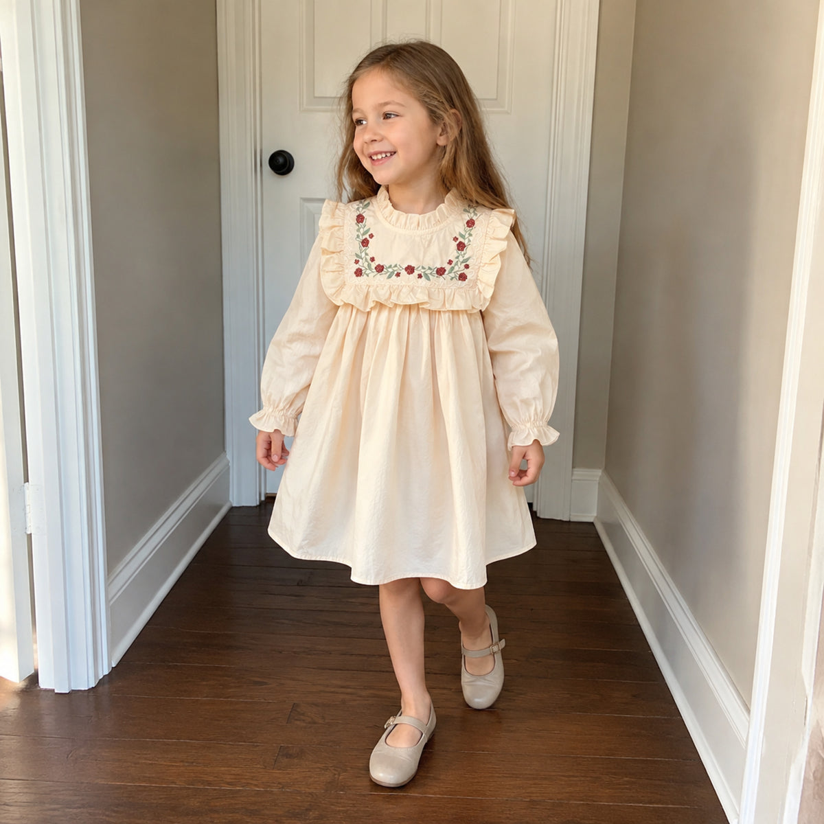 Girl wearing creamy embroidered cotton dress at home