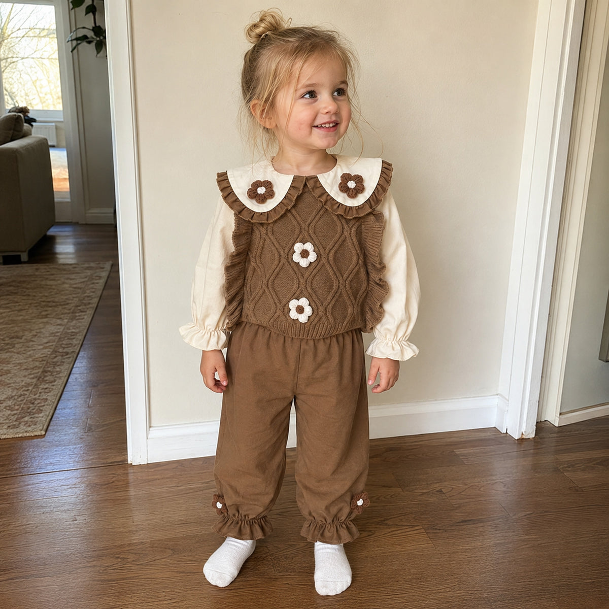 Toddler girl wearing coffee cable-knit vest outfit at home