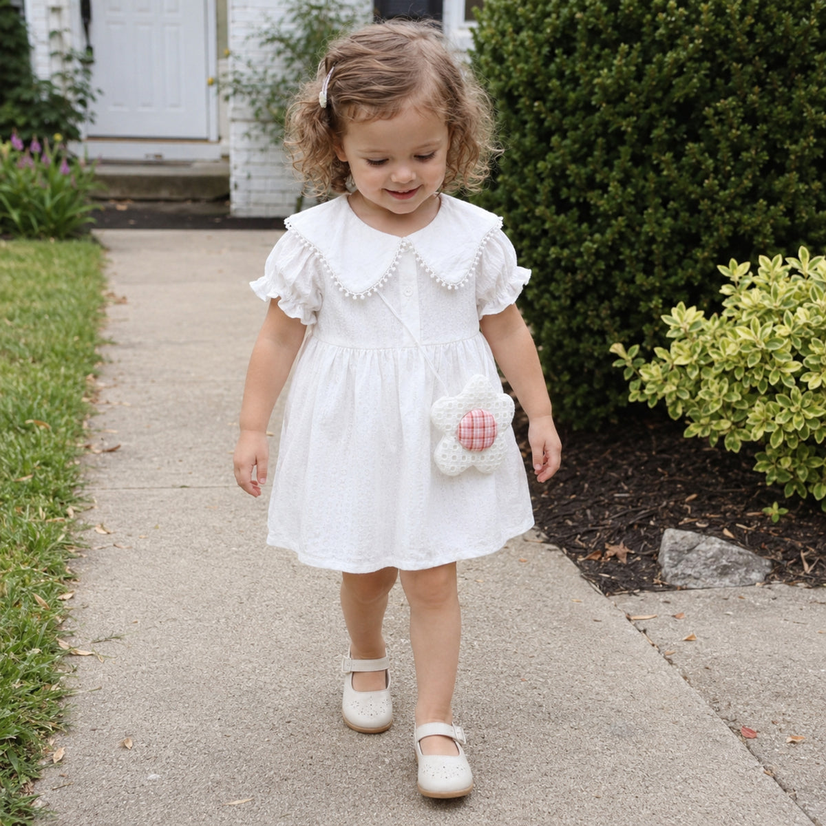 Girl wearing white flower pocket dress outdoors