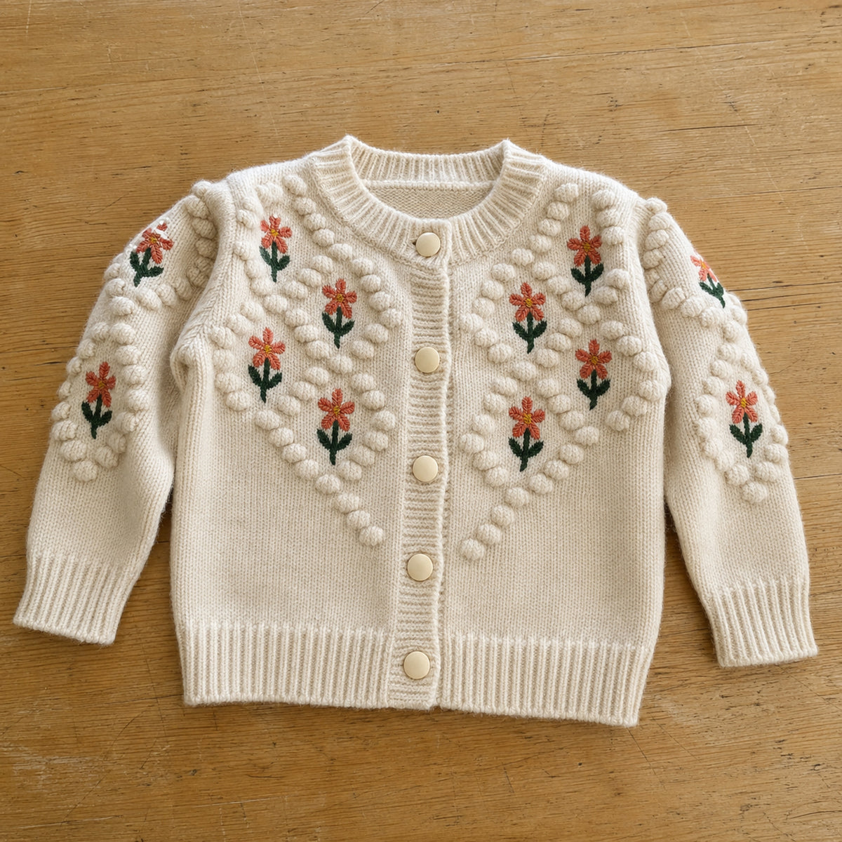 Beige flower embroidered cardigan flat lay