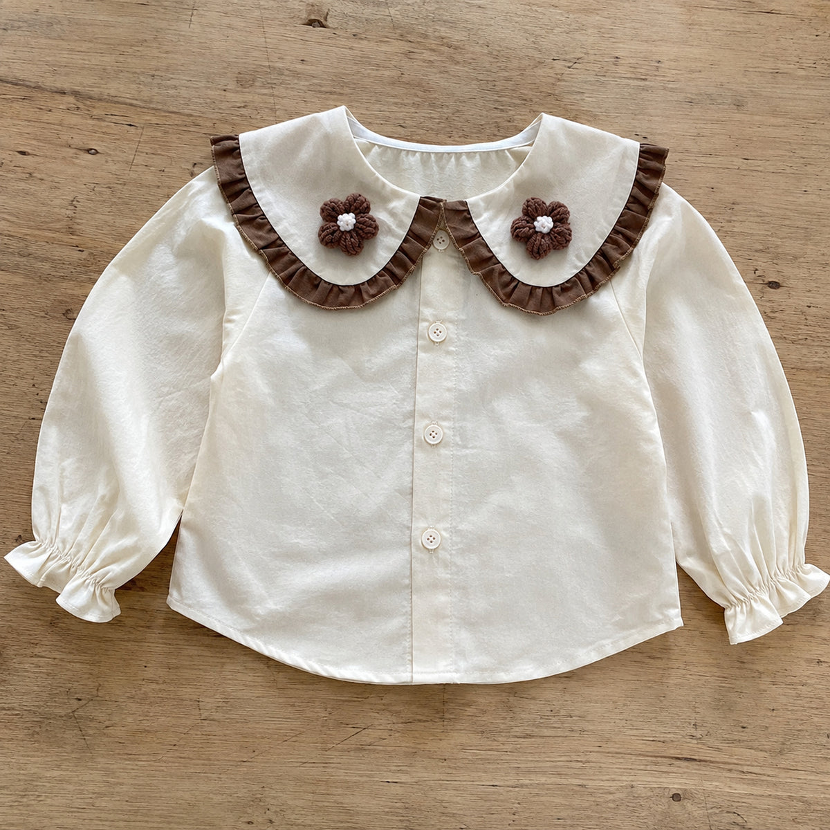 Ivory ruffle collar blouse with crochet flower details