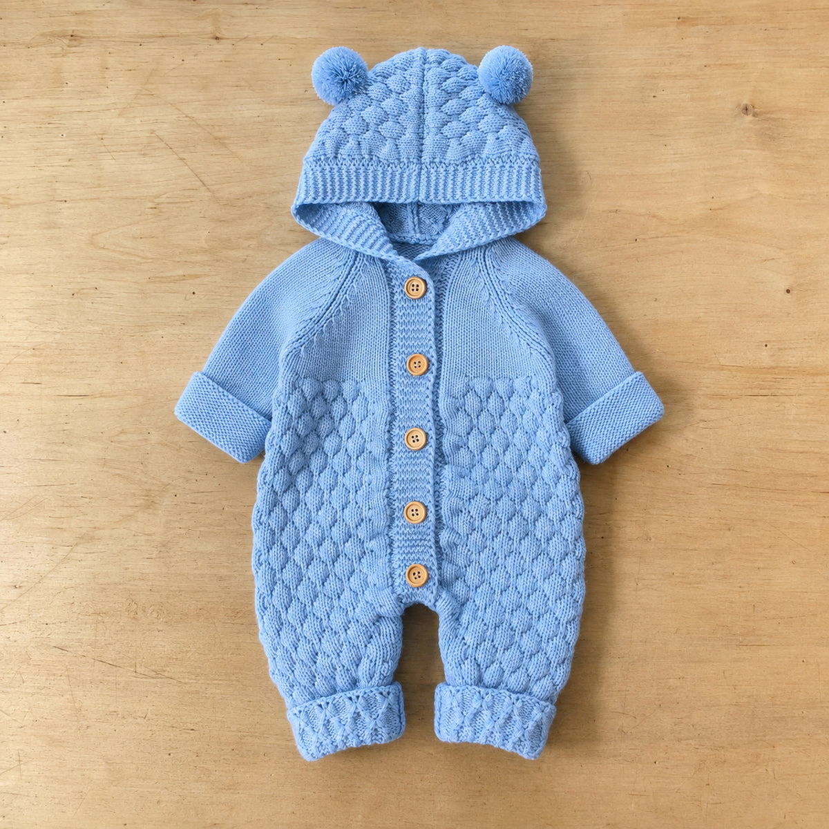 Baby blue bear ear hooded knit romper flat lay